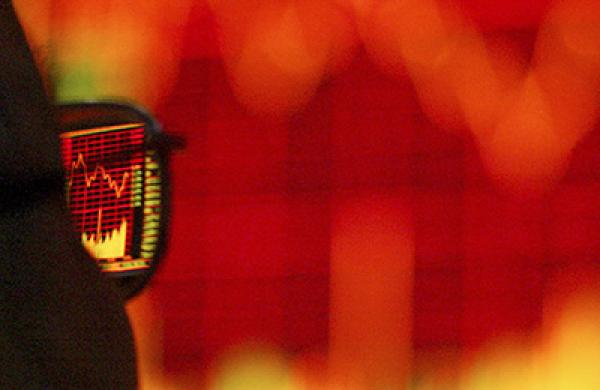 A Chinese customer walks pass the stock index at the end of the trading day in a stock trade floor  in Shanghai, China on 26 April, 2004. 