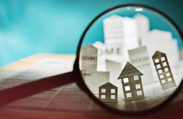 Paper house under a magnifying lens