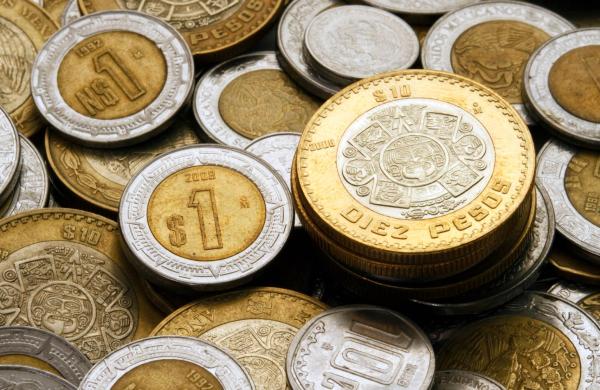 Ten Mexican Pesos Coin on a Pile of Coins