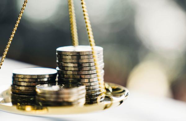 Coins stack with balance scale. Money management, financial plan, time value of money, business idea and Creative ideas for saving money concept.
