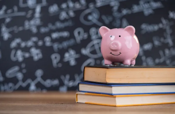 Piggy bank on books in classroom