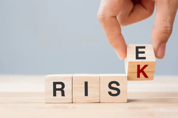 Businessman hand flipping wooden cube blocks with RISK change to RISE text on table background. economic, chance, attitude, opportunity and Crisis concepts - stock photo