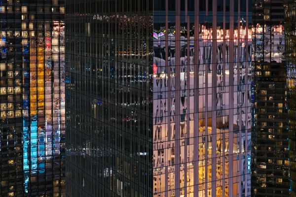 Drone View of Skyscrapers Reflecting Las Vegas Buildings at Night - stock photo