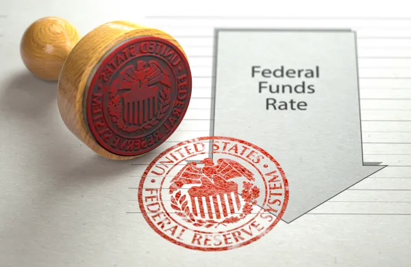 Federal funds rate decrease. Arrow with cut of federal fund rate and stamp of federal reserve FRS symbol.