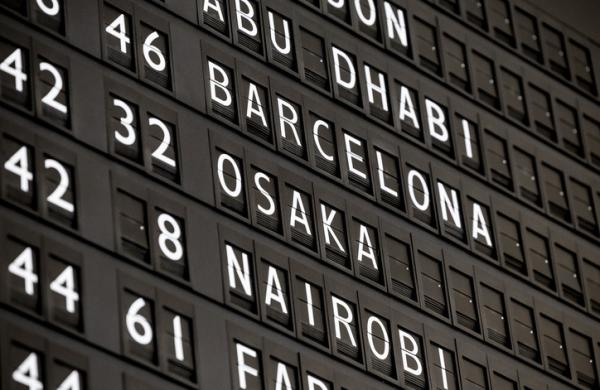 Retro style destinations on an arrival/departures board at the airport