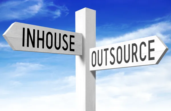 Outsource, inhouse - wooden signpost