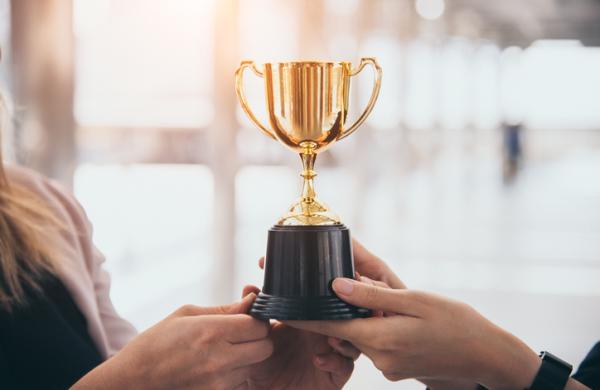 Champion golden trophy for winner background. Success and achievement concept. Sport and cup award theme. Best business entrepreneur and startup award and prize. First place on final competition