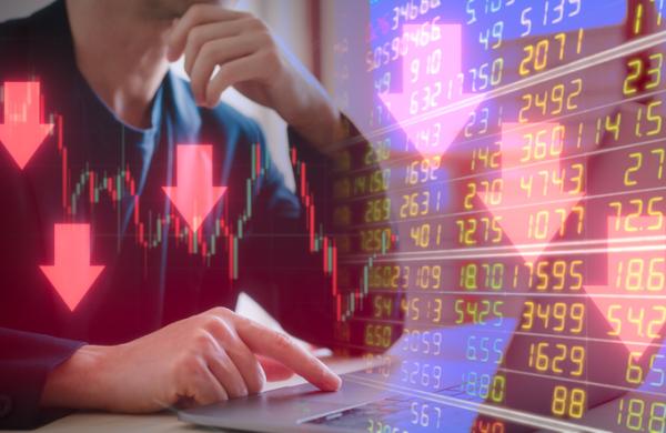 Investment financial property trading in down trend Businessman using computer working on virtual trading price and graph with arrow are pointing down
