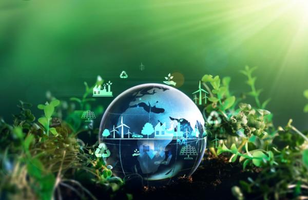 Green energy for clean and sustainable environment. Wind energy used in the industry of factories, machines and technologies. Reducing Co2 emissions and limiting global warming and climate change