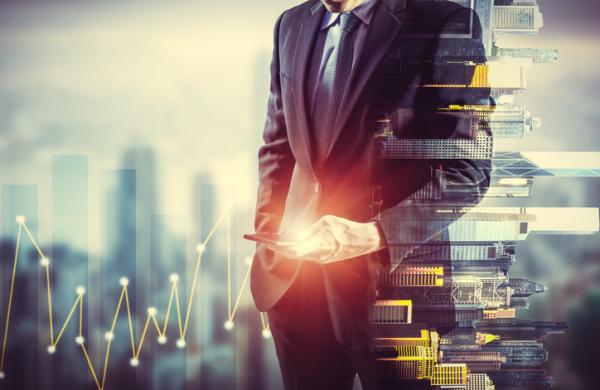 Businessman holding smart phone. Double exposure photo of city view background, Finance strategy concept.