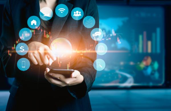 Businesswomen using mobile phone analyzing data and economic growth graph chart. Technology digital marketing and network connection.