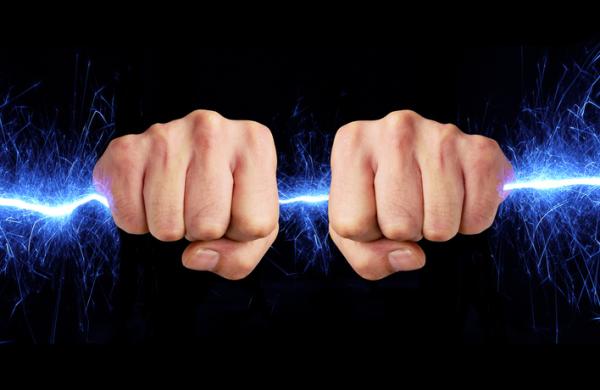 Hand holding blue sparks
