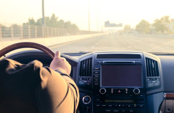 Inside the car, driving on the highway at sunset in Dubai UAE.