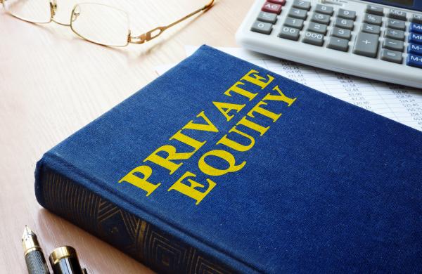 Book with title private equity and calculator.