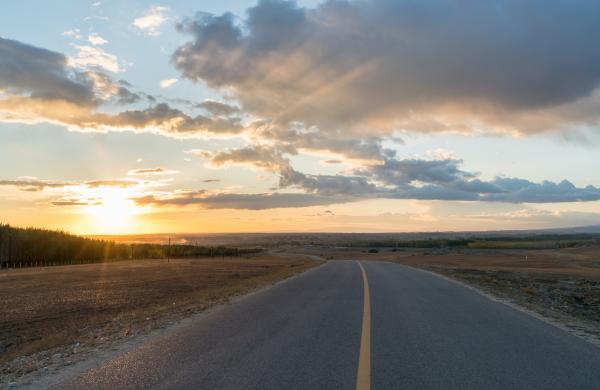 an empty road in the sunset