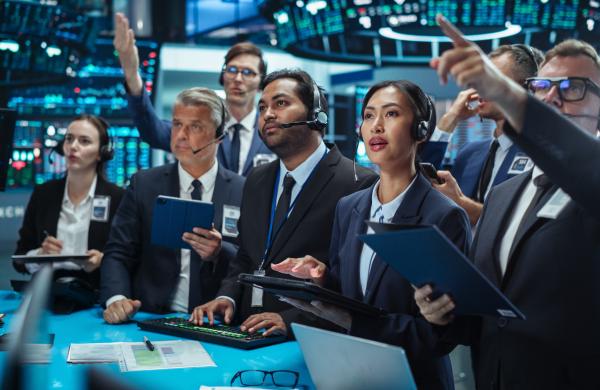 Diverse Stock Exchange Professionals Communicating in an Open Outcry Method on a Trading Floor. Men and Female Shouting and Using Hand Signals to Transfer Information About Buy and Sell Orders