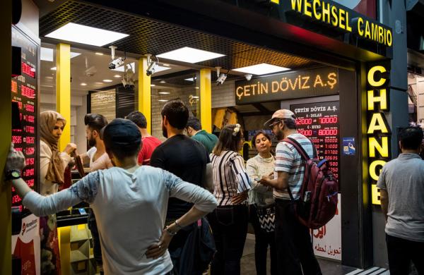 Tourists change money at a foreign currency bureau in Istanbul, Turkey. (Nicole Tung/Bloomberg)