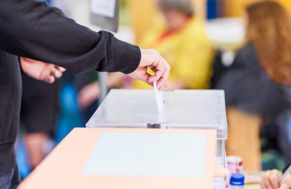 voting candidate campaign in democracy ballot box. Latin mid hand unrecognizable man