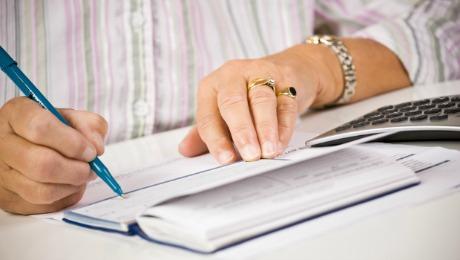 2016-06-julie-segal-longevity-senior-woman-writing-checks-large.jpg