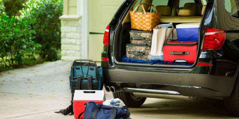 Family vehicle packed, ready for road trip, vacation outside home.