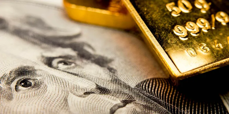 Close-up of a 20-dollar banknote (figuring president Jackson) and a gold bullion