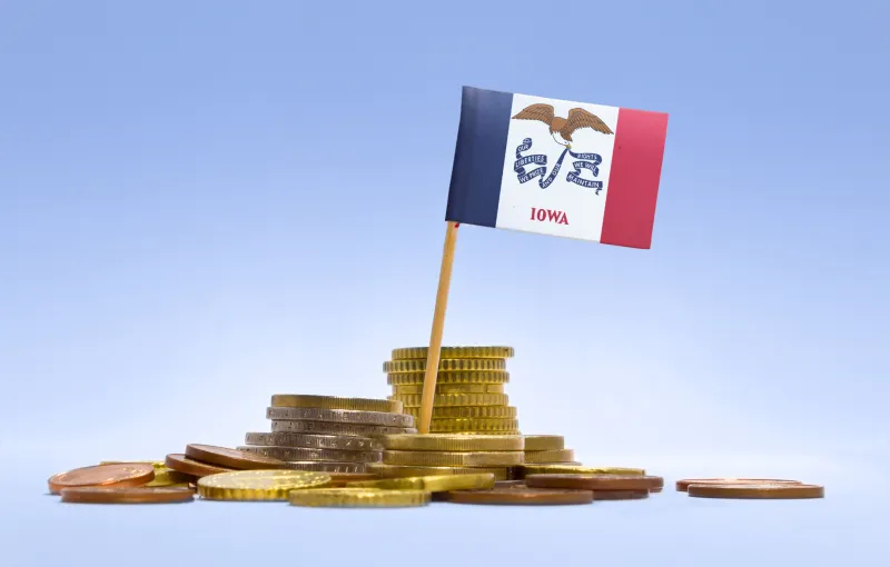 Iowa flag with a coin stack base, symbolizing Iowa and currency.