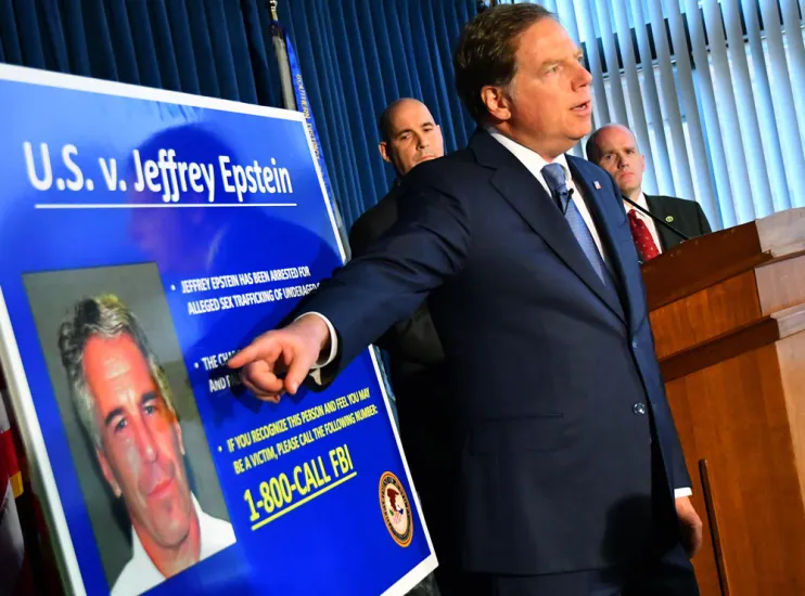 Geoffrey Berman, U.S. attorney for the Southern District of New York, speaks while standing next to a poster displaying the image of fund manager Jeffrey Epstein. (Louis Lanzano/Bloomberg) Geoffrey Berman, U.S. attorney for the Southern District of New York, speaks while standing next to a poster displaying the image of fund manager Jeffrey Epstein. (Louis Lanzano/Bloomberg)